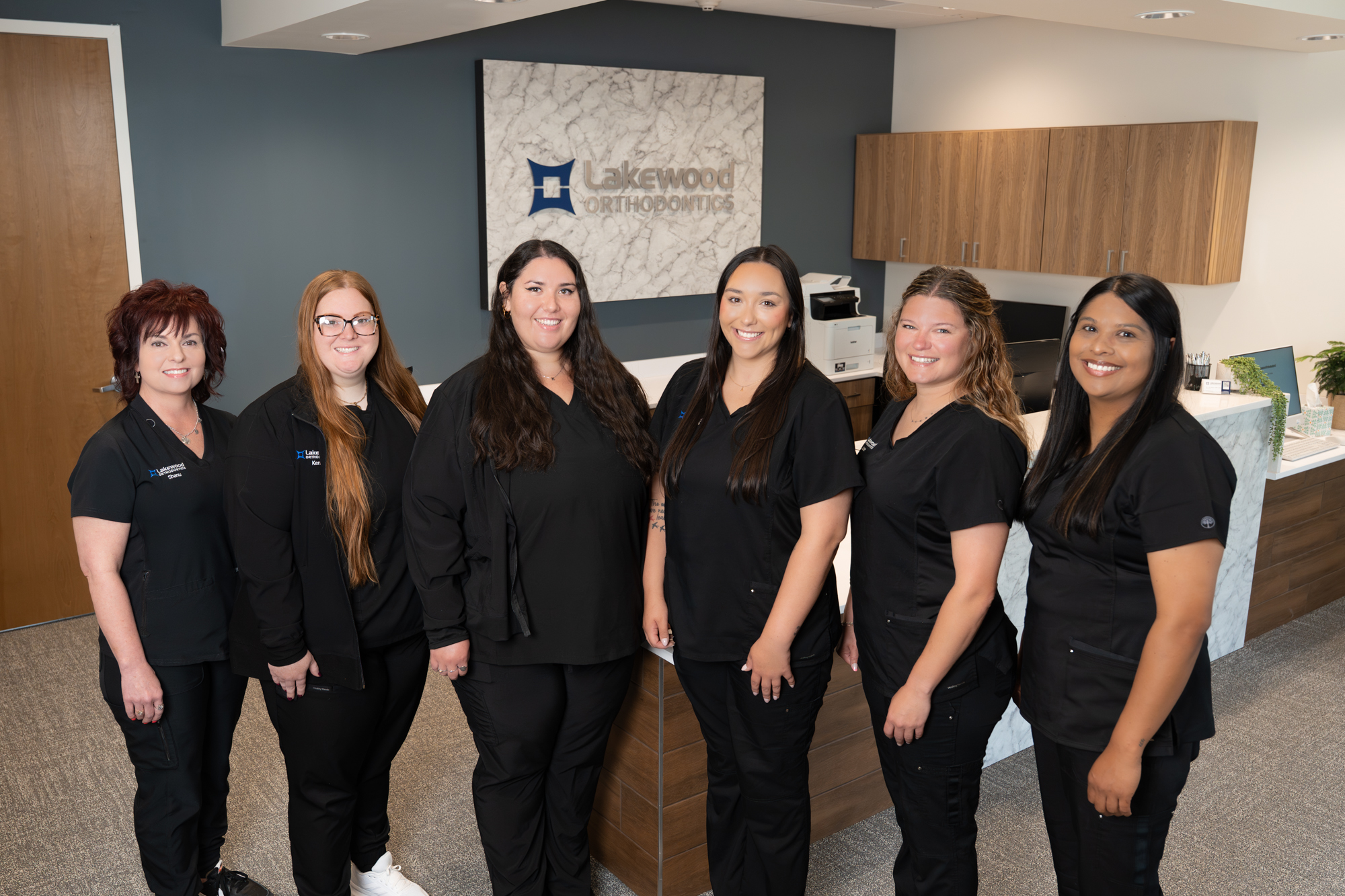 Lakewood Orthodontics team smiling and welcoming patients, showcasing friendly staff and orthodontist care in Lee’s Summit.