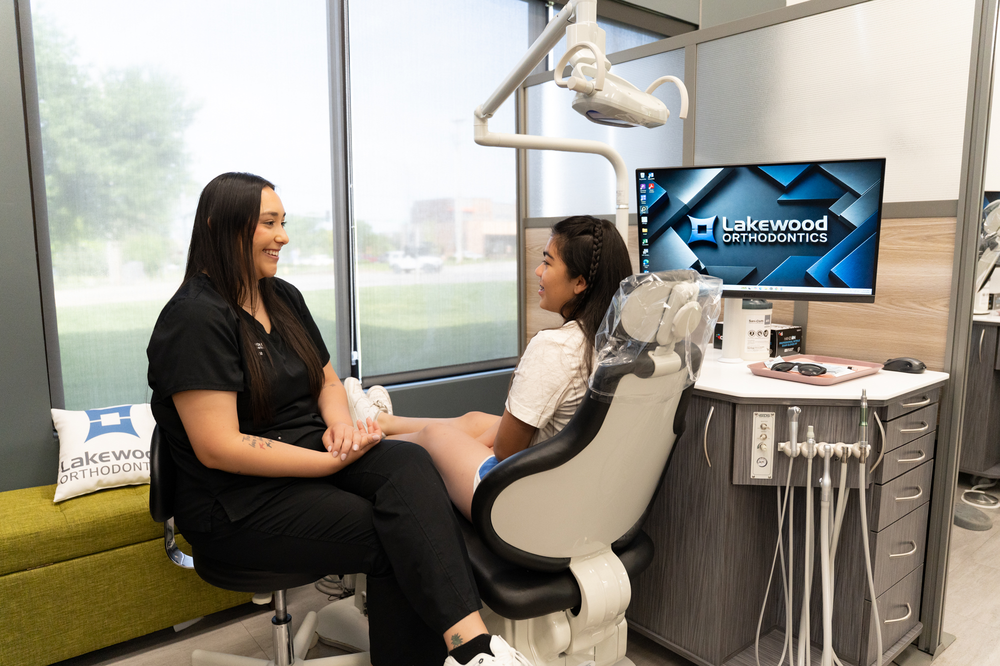 Orthodontist consultation at Lakewood Orthodontics in Blue Springs MO, patient in dental chair and orthodontist discussing treatment options.