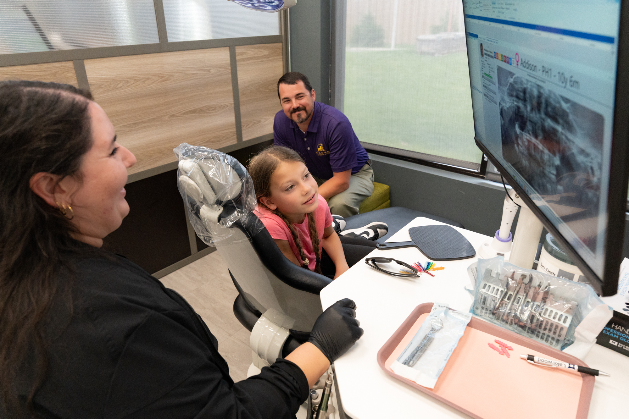 Family consulting with orthodontist about braces and clear aligners in Greenwood, MO at Lakewood Orthodontics.