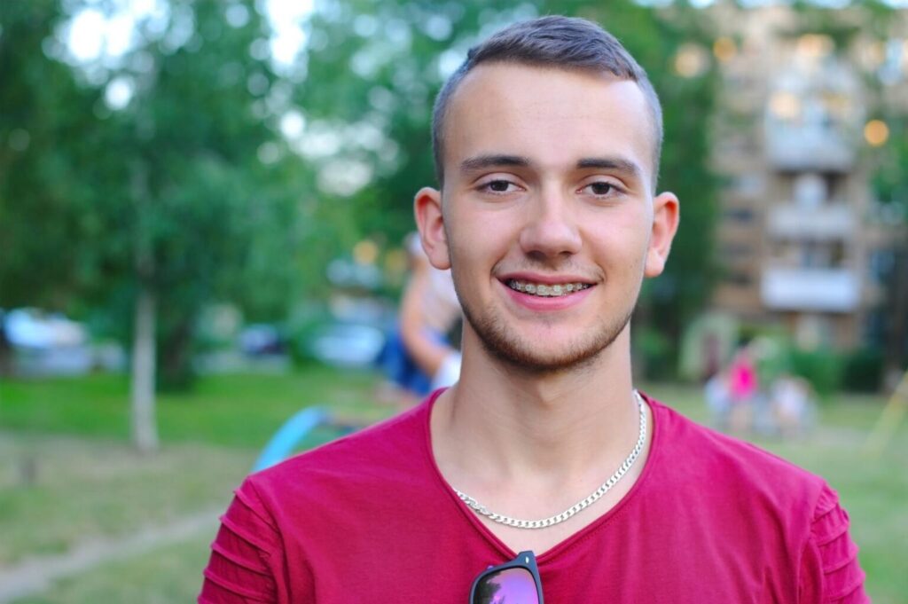 Smiling patient wearing clear braces